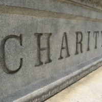 charity engraved on a stone plaque